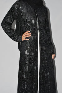 Black embossed velvet overcoat with intricate floral patterns and front zip closure
