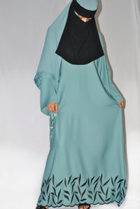 Teal embroidered closed abaya with black leaf detailing and matching headscarf