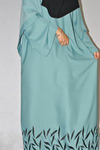 Light blue teal abaya with black leaf embroidery at the hem, modest fashion style