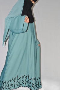 Teal embroidered abaya with black leaf pattern and wide sleeves, modest fashion style