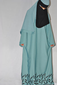 Light blue embroidered abaya with black floral pattern and matching headscarf