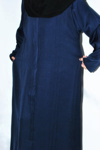 Navy blue open abaya with long sleeves and front pockets on plain background