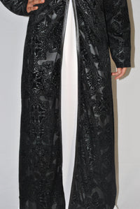 Black embossed velvet overcoat with intricate floral patterns and open front style