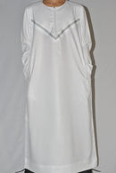 White embroidery detail on boys Omani thobe