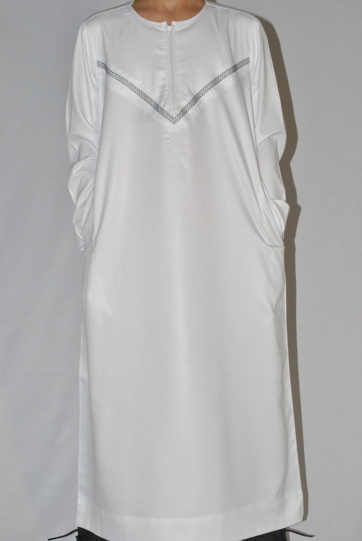 White embroidery detail on boys Omani thobe