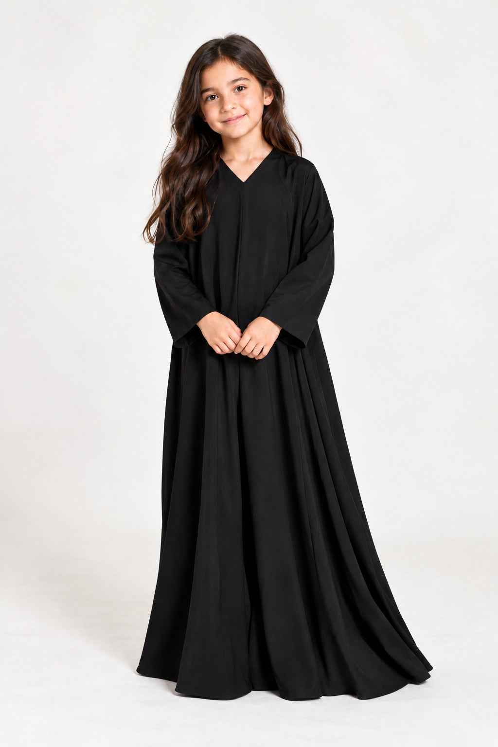Back view of a girls’ flowing black abaya showing its loose silhouette