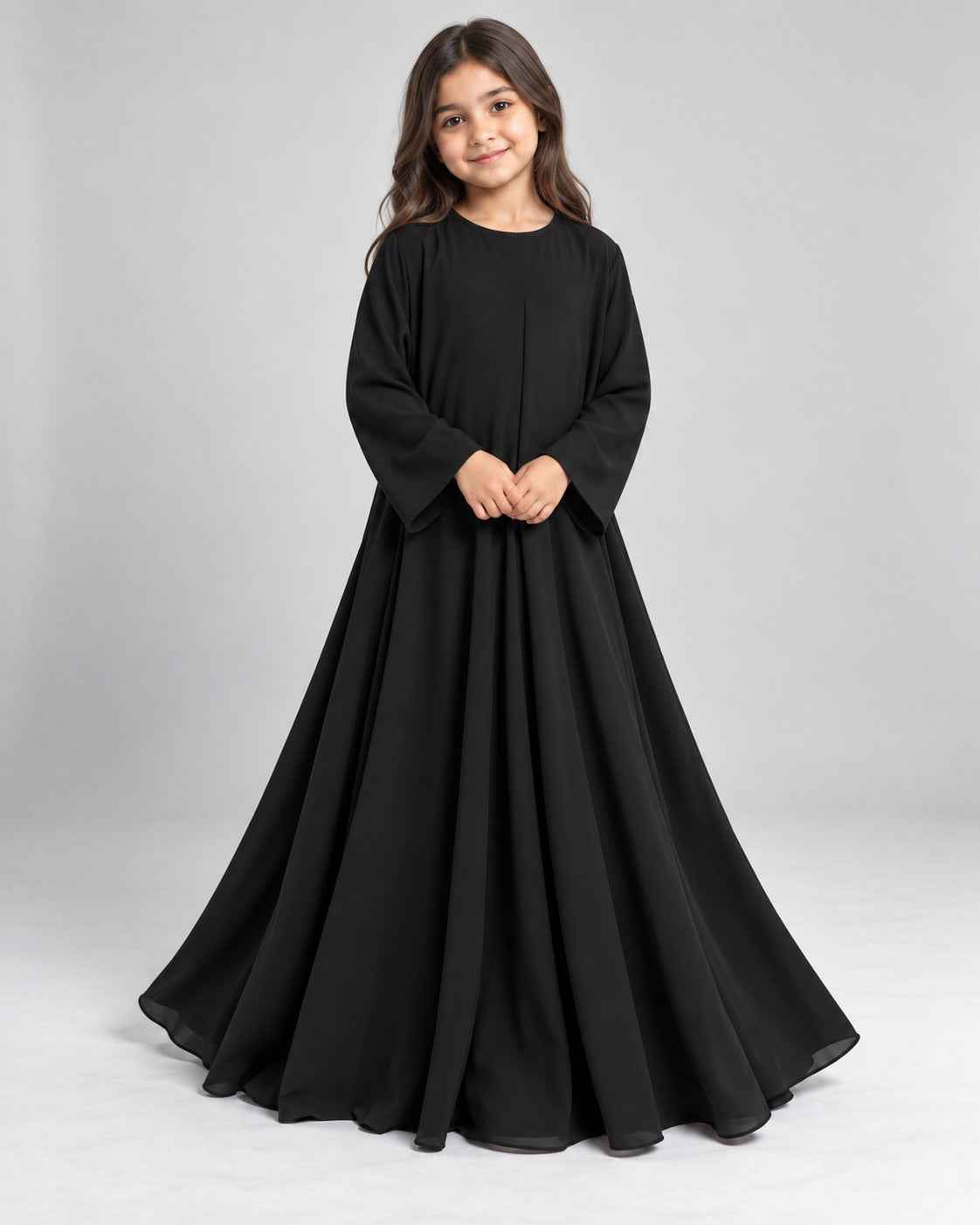 Front view of a girls’ flowing black abaya with a loose, modest fit
