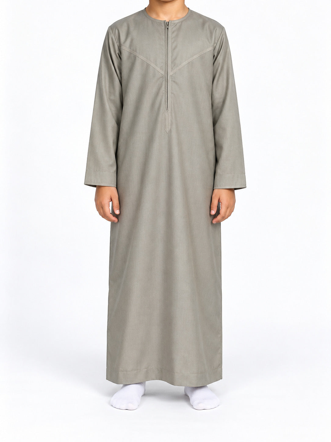 Boy wearing a cement grey Omani thobe with curved chest stitching, front view