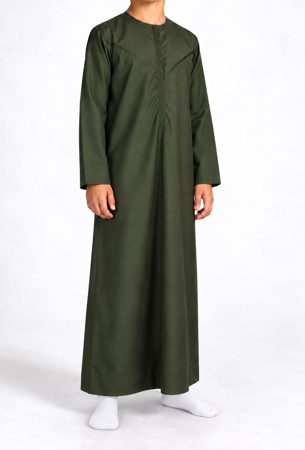 Boy wearing a forest green Omani thobe with curved chest stitching, front view