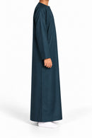 Side view of a boy wearing a dark marine blue Omani thobe