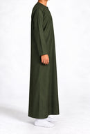 Side view of a boy wearing a forest green Omani thobe