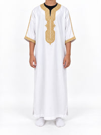 Boy wearing a white Moroccan thobe with gold embroidery and sleeves extending below the elbows, front view