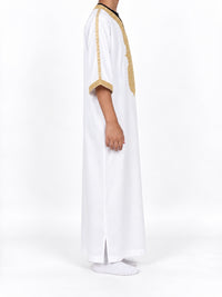 Side view of a boy wearing a white Moroccan thobe with gold sleeve trim and sleeves extending below the elbows