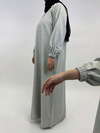 Beige linen fabric detail on women’s closed abaya