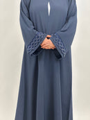 Side view of women’s navy embroidered open abaya