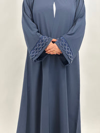 Side view of women’s navy embroidered open abaya