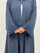 Embroidery detail on women’s navy open abaya