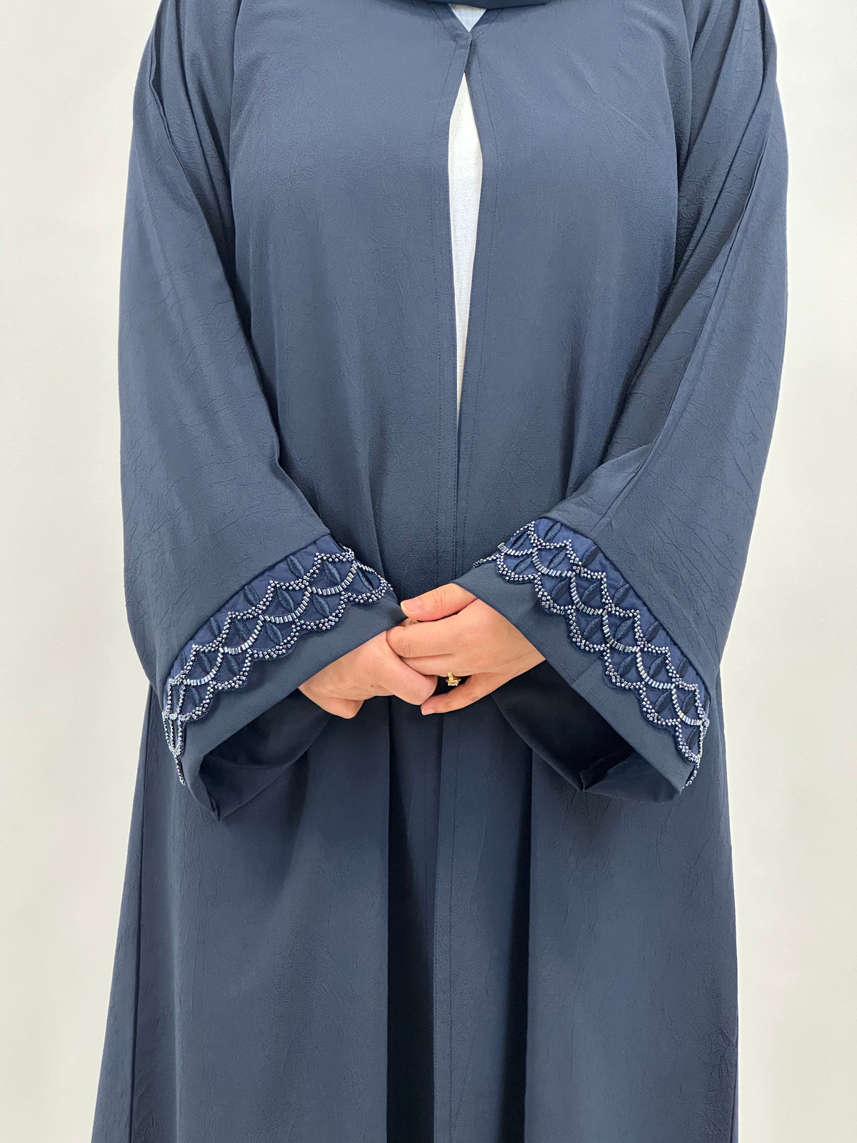 Embroidery detail on women’s navy open abaya